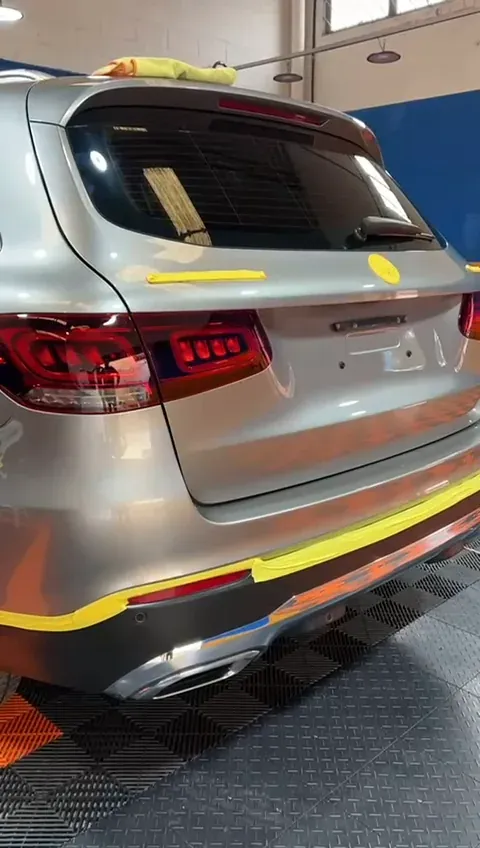 Traseira de um Mercedes-Benz GLC com fita amarela isolando os frisos, pronta para o polimento